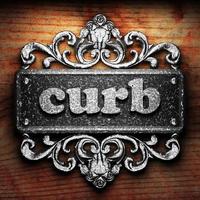 curb word of iron on wooden background photo