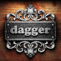 dagger word of iron on wooden background photo