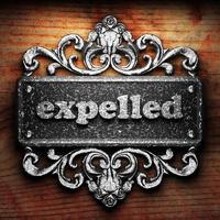 expelled word of iron on wooden background photo