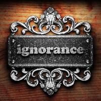 ignorance word of iron on wooden background photo