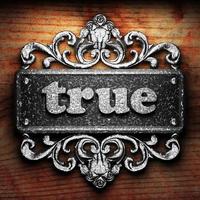 true word of iron on wooden background photo