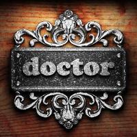 doctor word of iron on wooden background photo