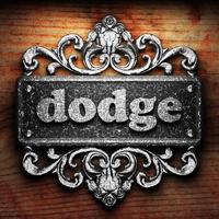 dodge word of iron on wooden background photo