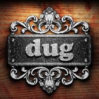 dug word of iron on wooden background photo