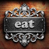 eat word of iron on wooden background photo