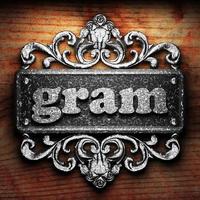 gram word of iron on wooden background photo