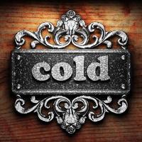 cold word of iron on wooden background photo