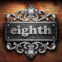 eighth word of iron on wooden background photo