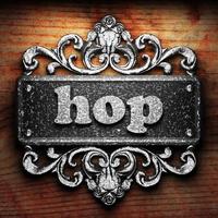 hop word of iron on wooden background photo
