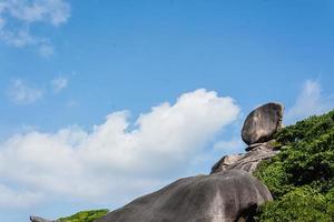 Beautiful landscape people on rock is a symbol of Similan Islands, blue sky and cloud over the sea during summer at Mu Ko Similan National Park, Phang Nga province, Thailand photo