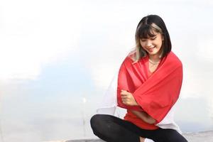 excited asian woman  holding indonesian flag on indonesia independence day photo