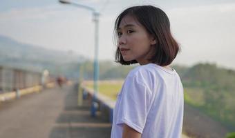 Young Asian woman is running and jogging an outdoor workout on the road in the morning photo