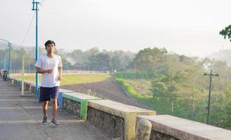 young asian man having jogging in the morning photo