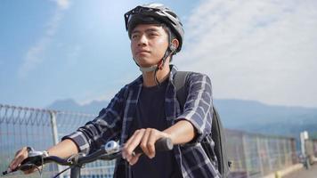 asian youth riding bicycle to work