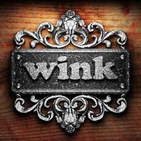 wink word of iron on wooden background photo