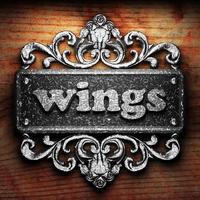 wings word of iron on wooden background photo