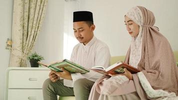 young asian couple reading quran together photo