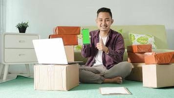 asian business man gesturing clear on his smartphone screen in the room photo