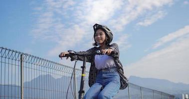 Young Asian woman ride bikes to work she is happy and safe photo