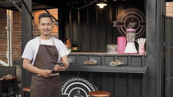 asian bar apron man preparing menu list in container theme angkringan photo