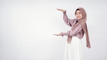 Asian hijab woman showing blank sideways isolated on white background photo