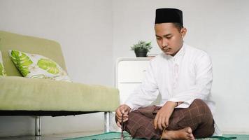 Asian muslim man doing dhikr photo