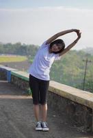 Young Asian woman has  streaching before doing jogging and running in the morning photo