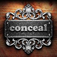 conceal word of iron on wooden background photo
