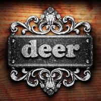 deer word of iron on wooden background photo