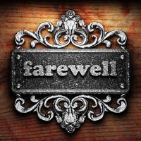 farewell word of iron on wooden background photo