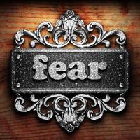 fear word of iron on wooden background photo