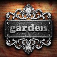 garden word of iron on wooden background photo