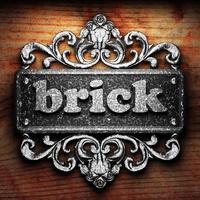 brick word of iron on wooden background photo