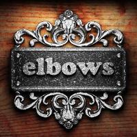 elbows word of iron on wooden background