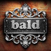 bald word of iron on wooden background photo