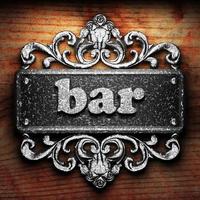 bar word of iron on wooden background photo