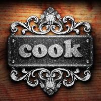 cook word of iron on wooden background photo