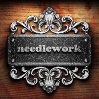 needlework word of iron on wooden background photo