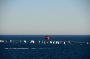 red ship and sailboats photo