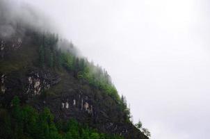 mountain slope in the fog photo