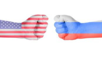 USA vs russia conflict symbolized by two fists painted with flags photo