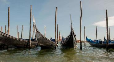 Gondola at jetty with background Giudecca in Venice photo