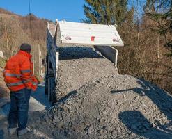 Rollover of gravel from trucks photo