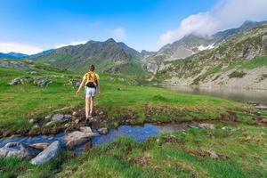 Trekking in the mountains near a creek pond photo