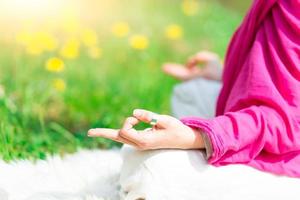 Position yoga practice it a woman in nature in spring flowers photo