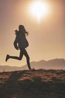 A little girl runs through the meadows photo