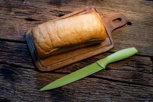 loaf bread isolated on wood background photo