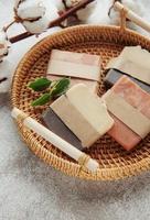 Handmade soap bars and green leaves photo