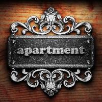 apartment word of iron on wooden background photo