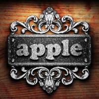 apple word of iron on wooden background photo